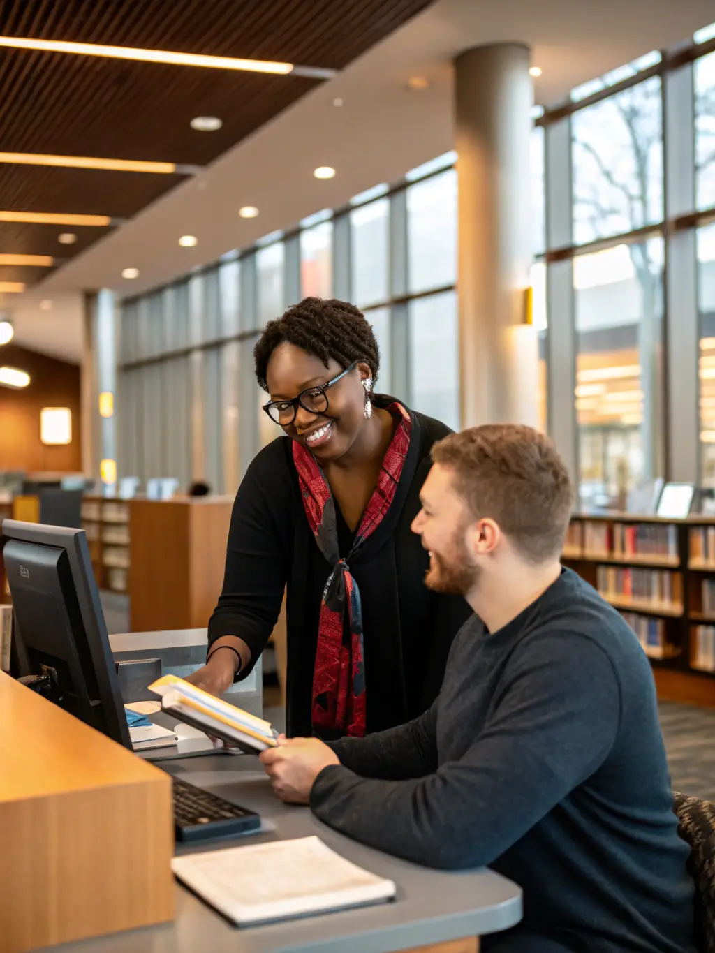 A photo of a librarian assisting a patron with research, emphasizing personalized support and guidance.